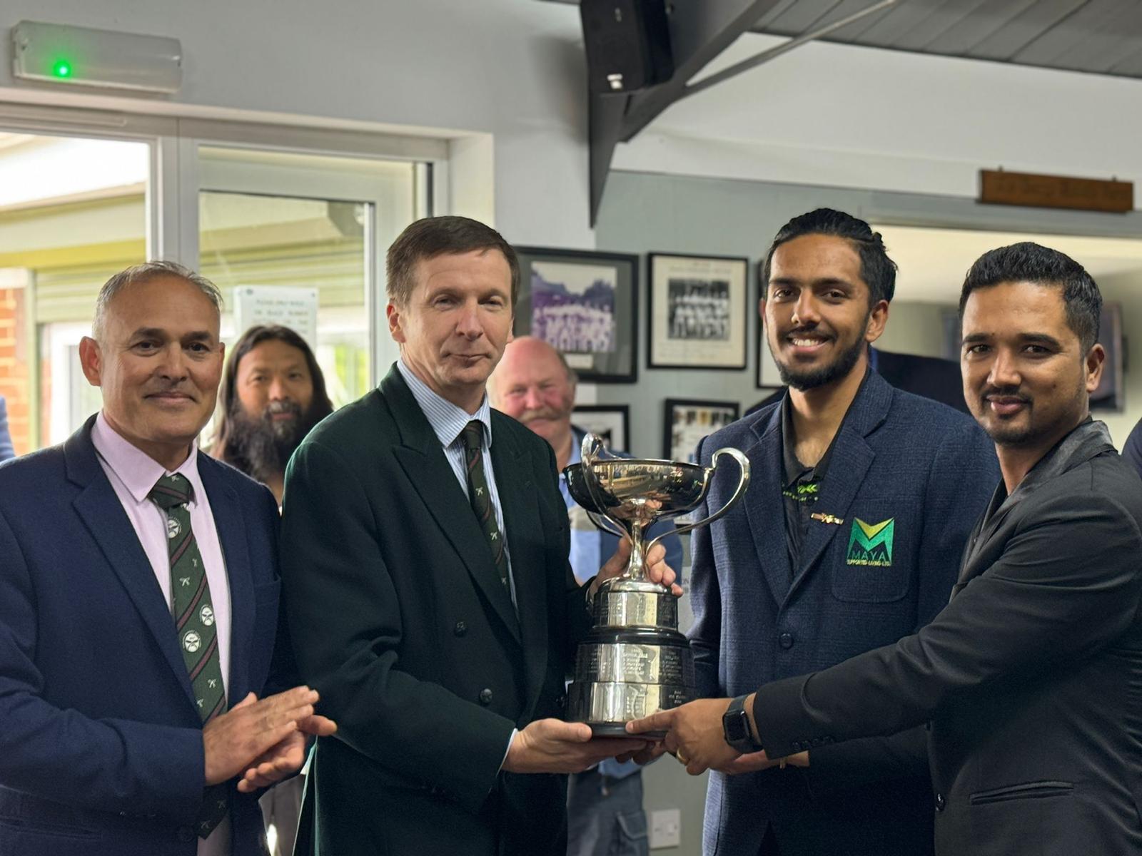 Cup being presented to winners Maya CC by Col BG