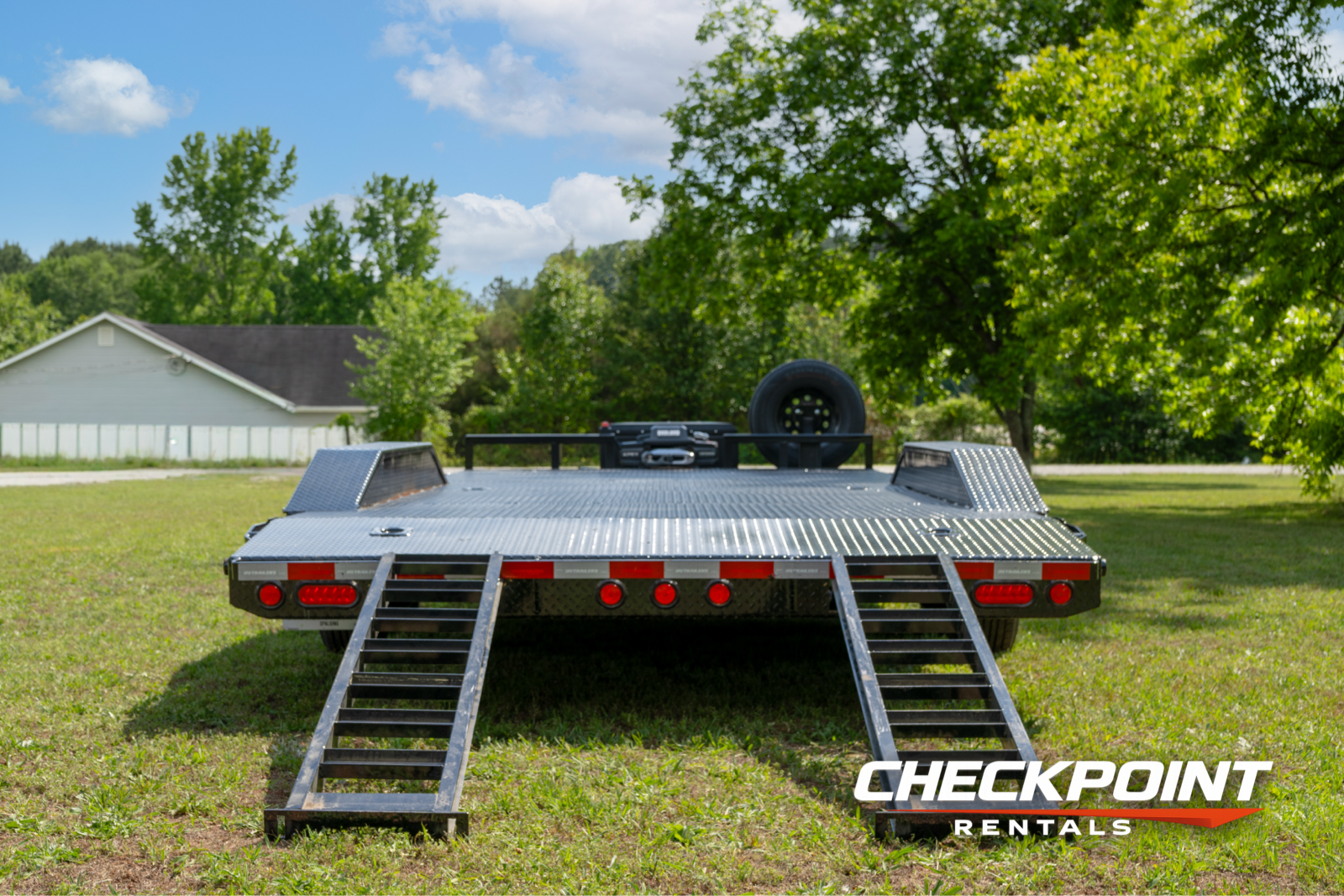 Car hauler rear view with slide-out loading ramps fully deployed