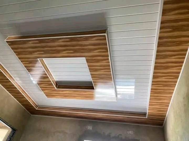 Geometric white and timber-look ceiling installation in progress