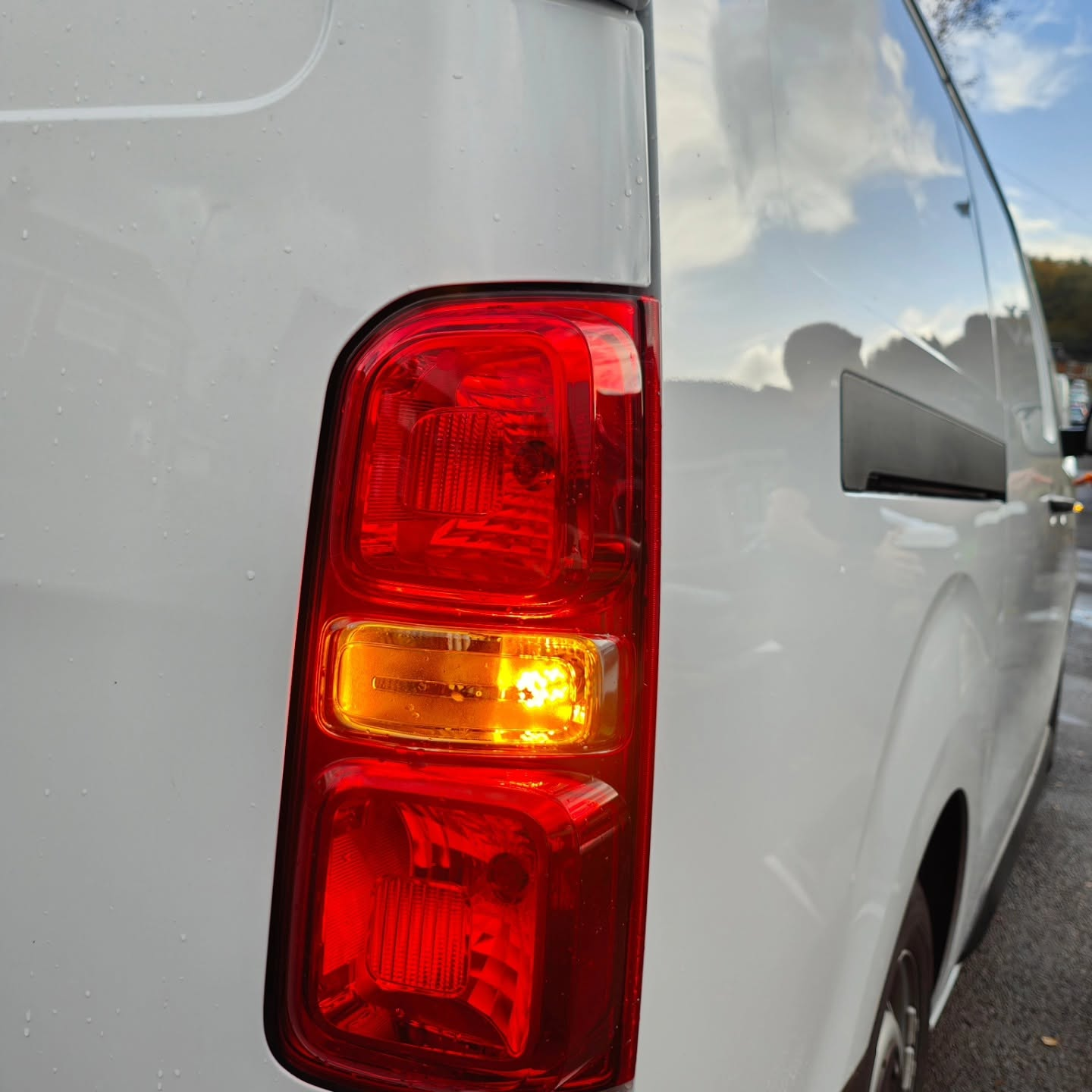 Close-up of a white van tail light with red and amber indicators lit — fault finding and diagnostics