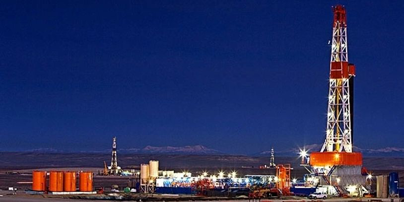 Gas drilling rig at night