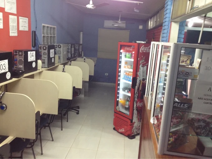 Vista geral da Lan House com computadores e área de lanchonete