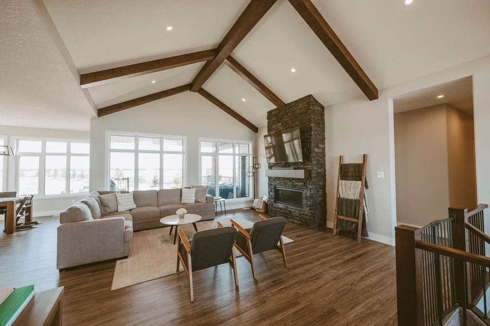 Living room with vaulted ceiling and stone fireplace