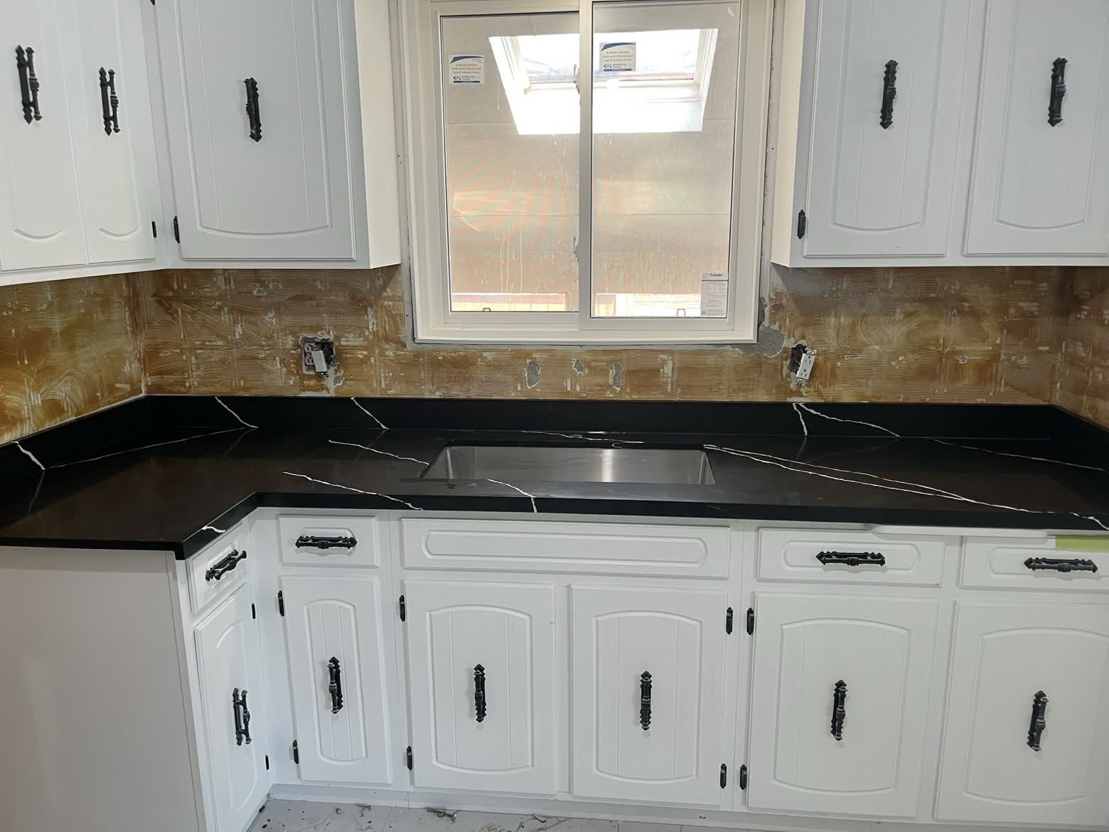 White kitchen with black quartz countertop