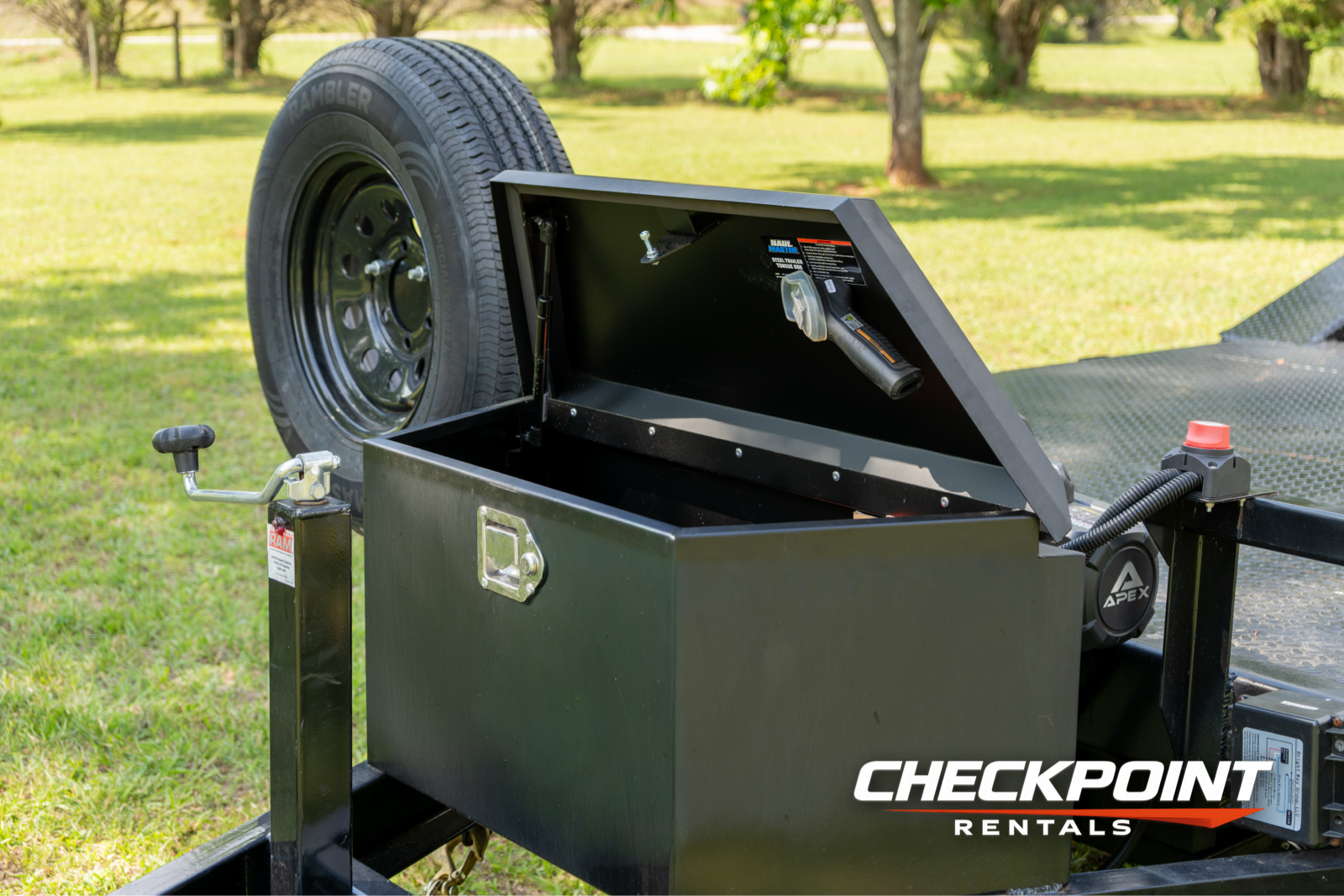 Front storage toolbox open showing winch cable and tongue jack