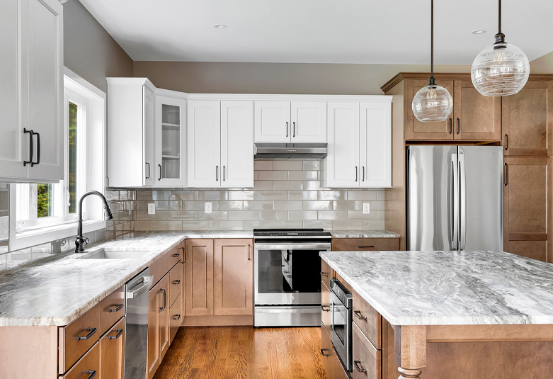 White and wood kitchen with marble countertops