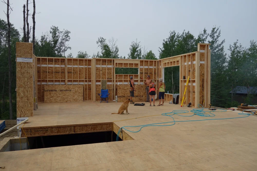 Wall framing stage with workers on site