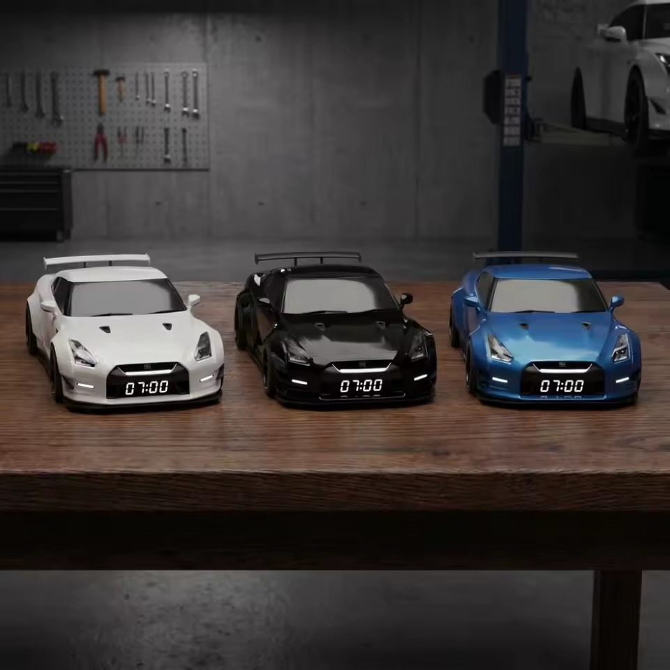 Black, white, and blue sports car alarm clocks displayed together