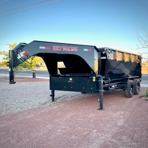 Front angle of black gooseneck roll-off dumpster showing hydraulic jacks and storage toolbox