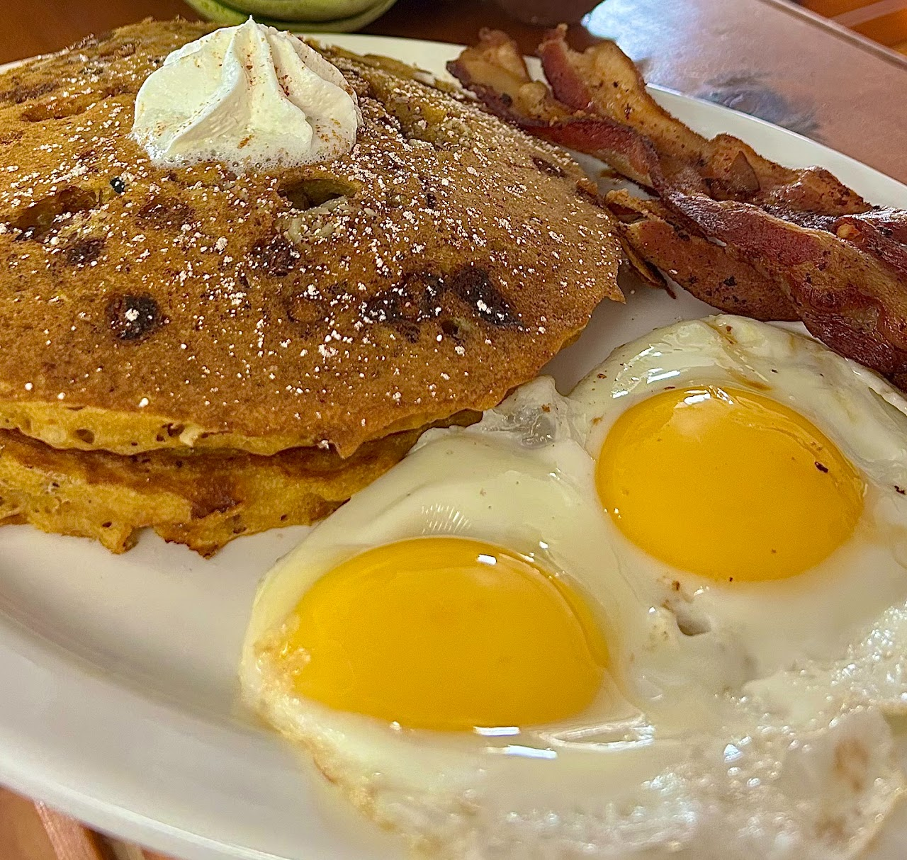 Blueberry pancakes with eggs and bacon