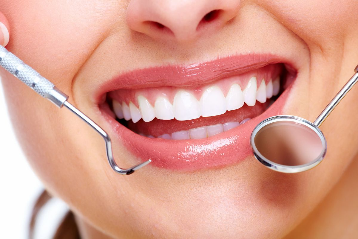 Patient smiling during a dental examination at Confident Smiles