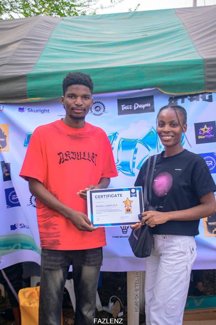Russell Damilola receiving certificate