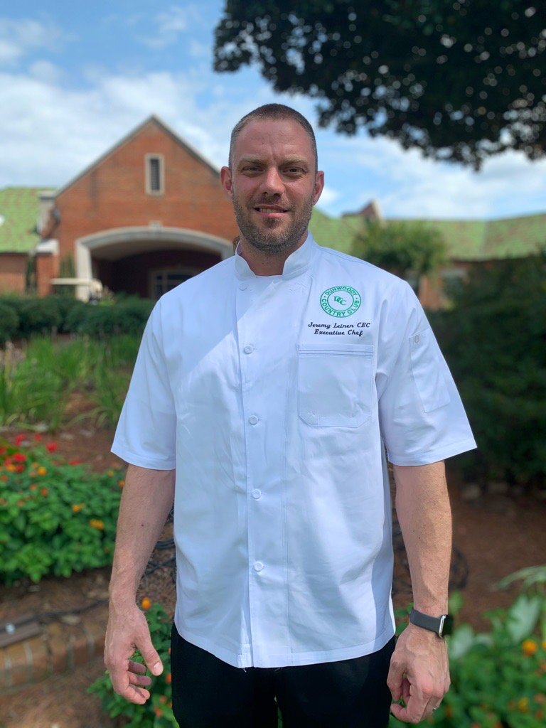 Jeremy Leinen in chef whites outside the clubhouse gardens