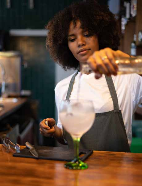 Professional bartender crafting signature cocktail with fresh ingredients - mixologist South Florida