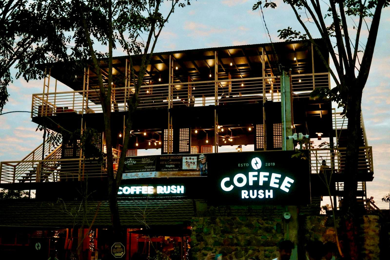 Coffee Rush Eastridge exterior at dusk with illuminated signage