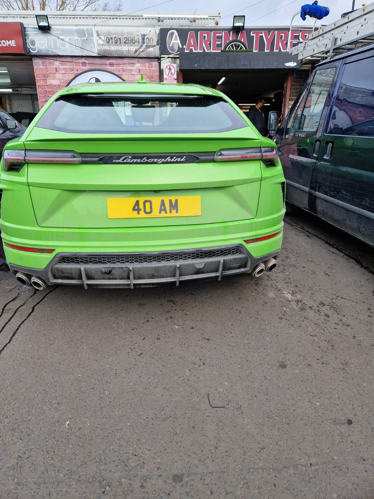Green Lamborghini Urus rear outside Arena Tyres shop