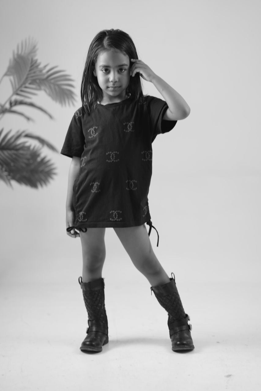 Child model in a black shirt and boots