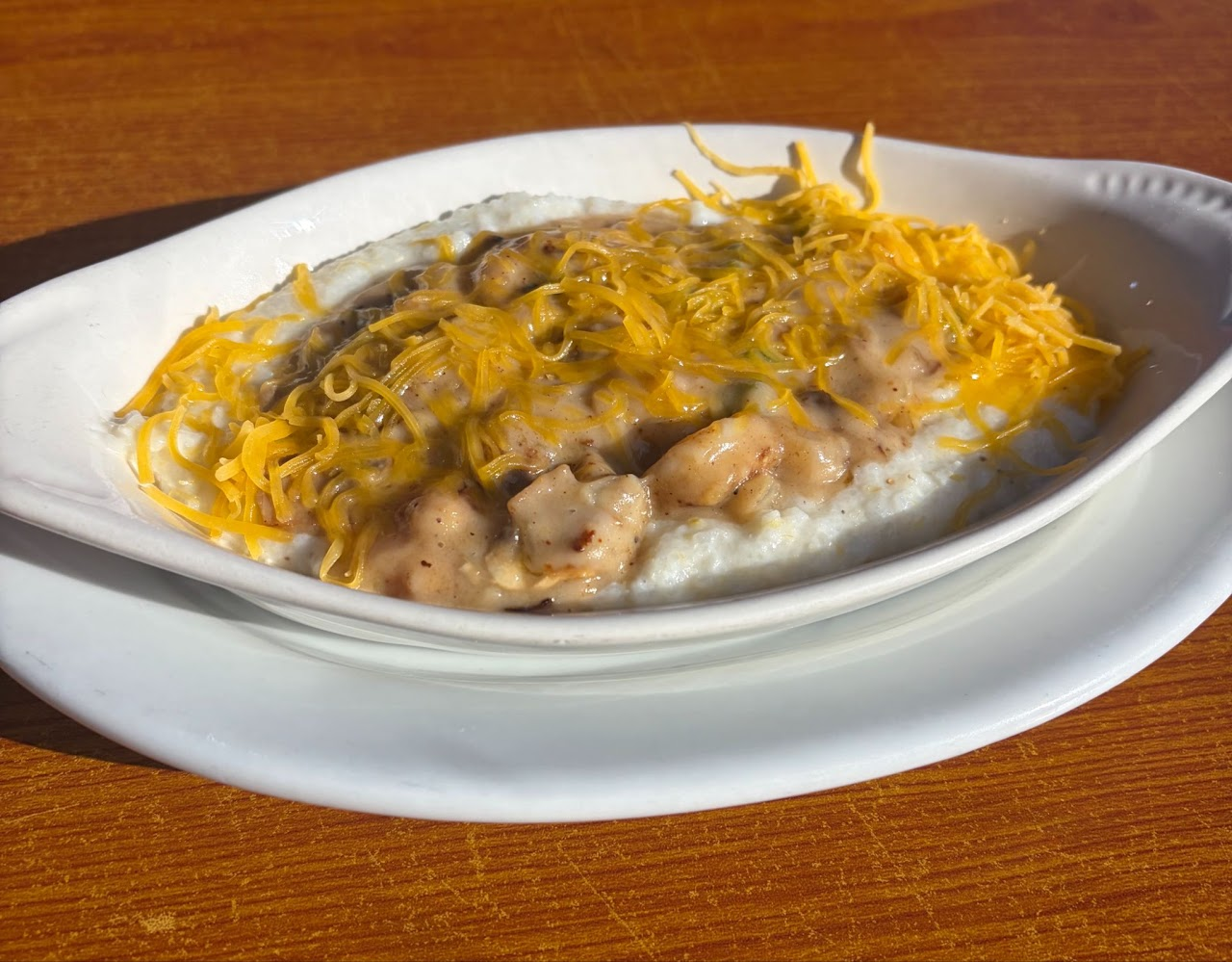Shrimp and grits topped with cheddar cheese