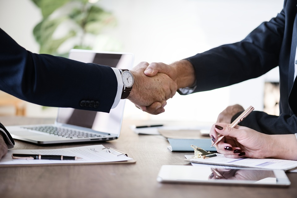 Business handshake over signed documents