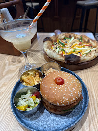 Gourmet food platter with burger, drinks and pizza