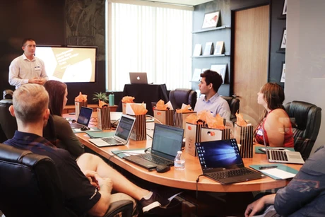 Team meeting in a conference room with laptops and presentation