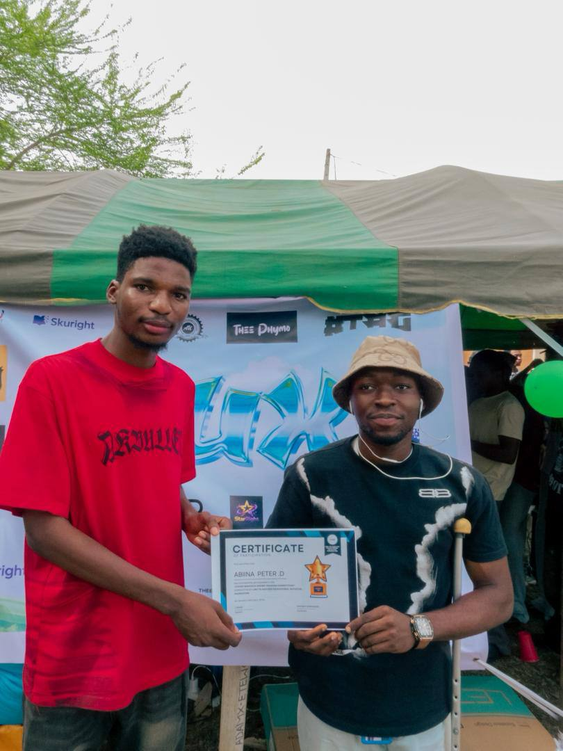 Abiina Peter D receiving certificate