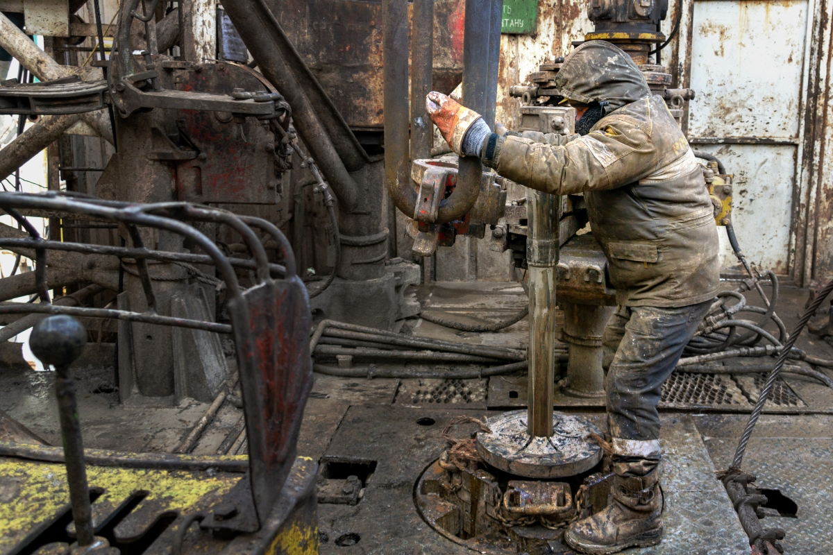 Oil rig worker operating drilling equipment