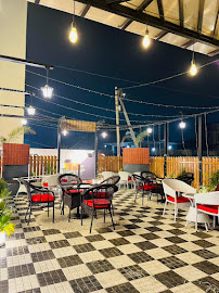 WaB Cafe rooftop terrace with string lights and checkered floor at night