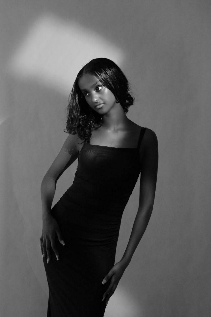Black and white portrait of a model in a fitted dress