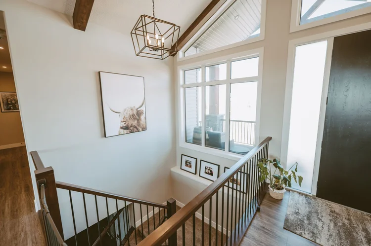 Stairwell with highland cow art and pendant
