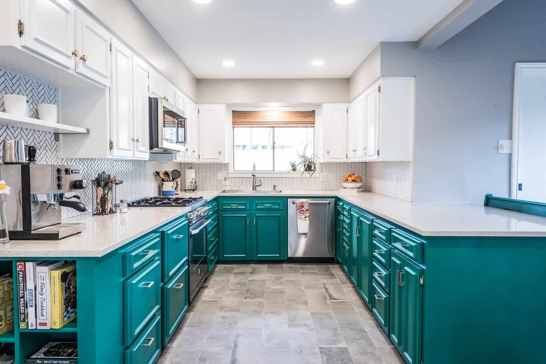 Teal and white kitchen with herringbone backsplash