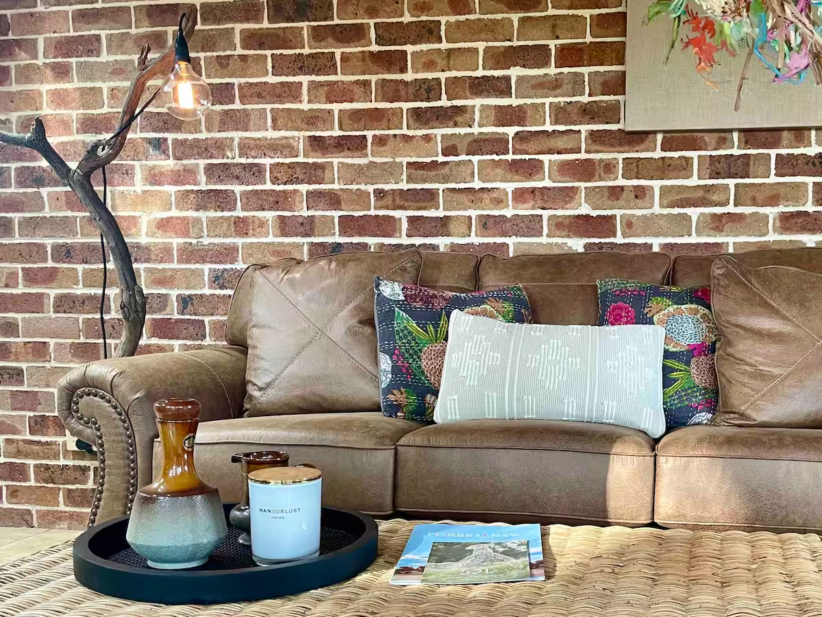 Living area with leather sofa and exposed brick