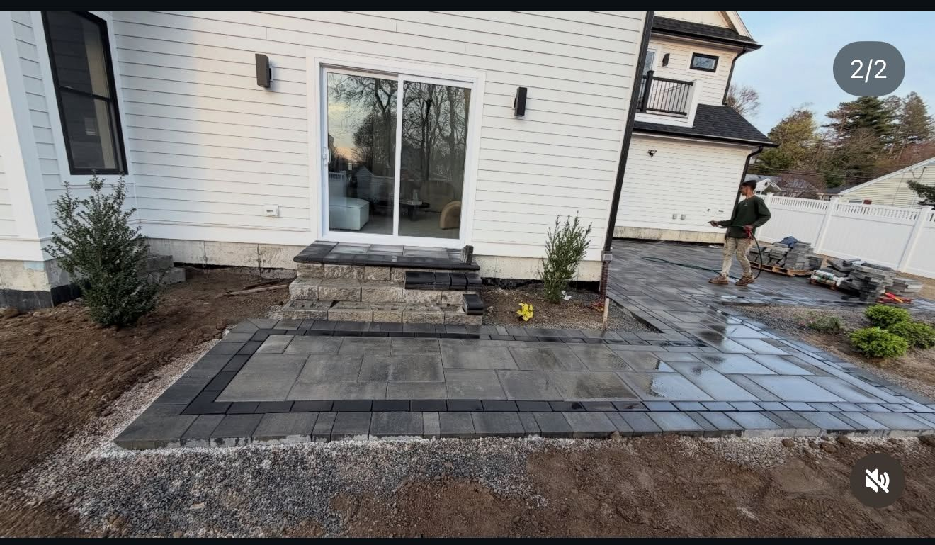 Bluestone patio with dark border pavers being installed at a luxury home