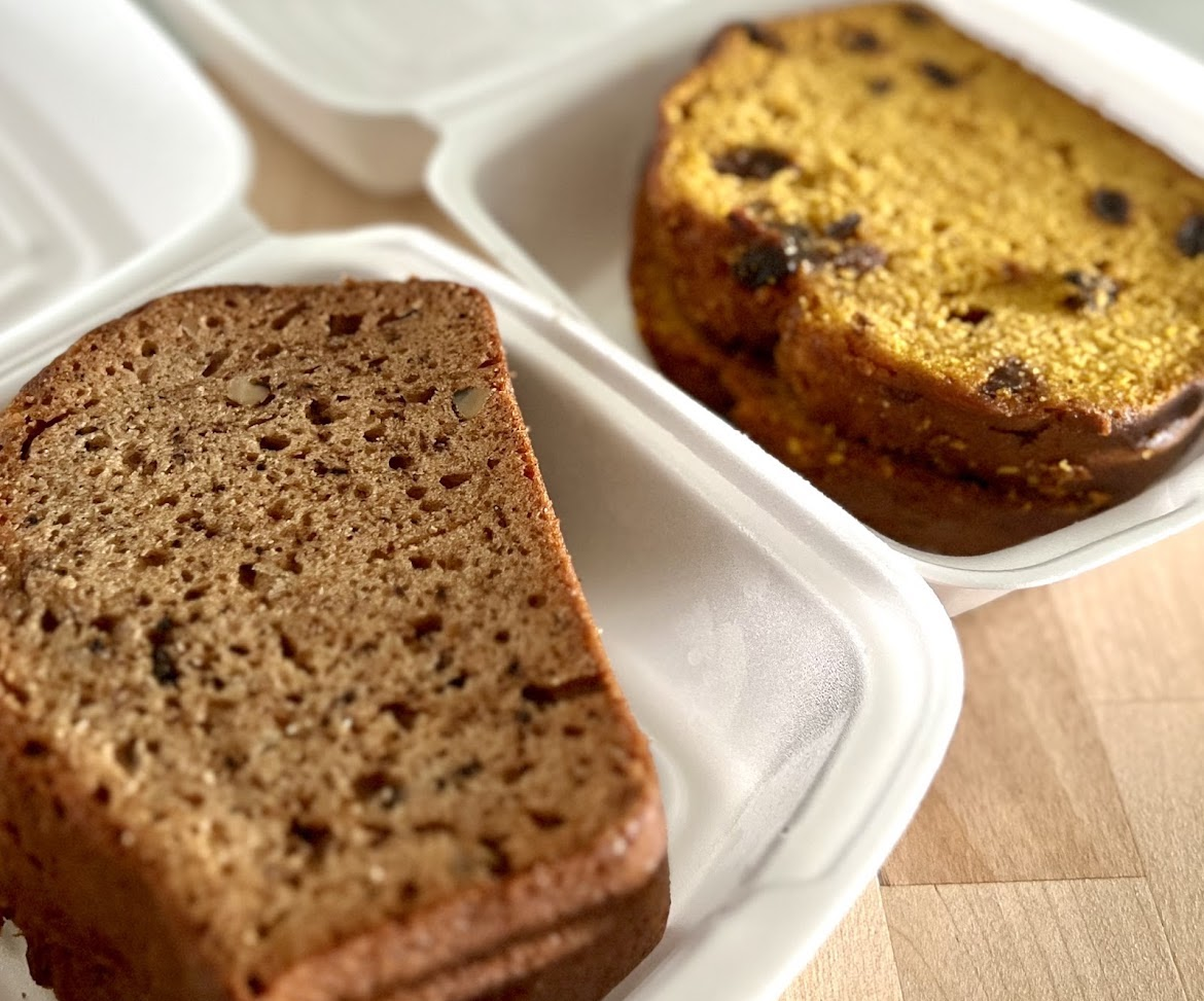 Slices of homemade bread in takeout containers