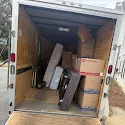 Enclosed trailer interior packed with boxes and furniture