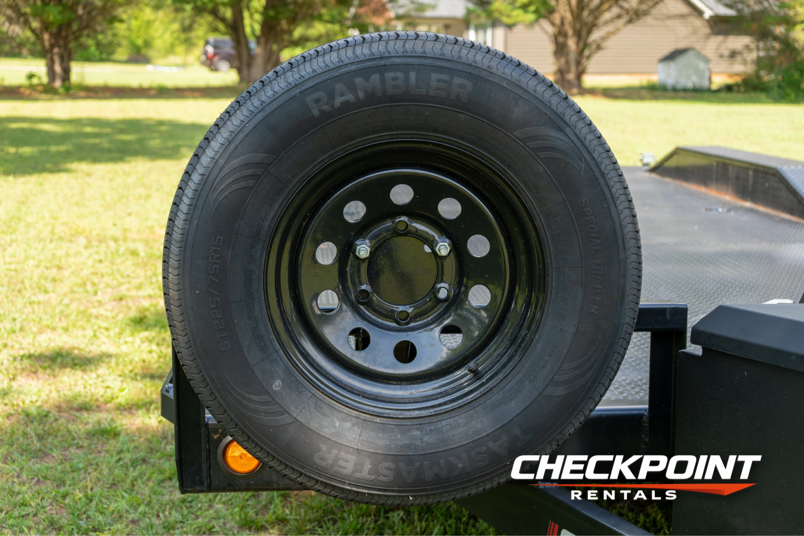 Rambler spare tire and black steel wheel on car hauler