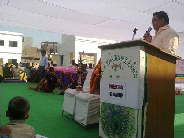 Yoga Mega Camp with speaker at podium
