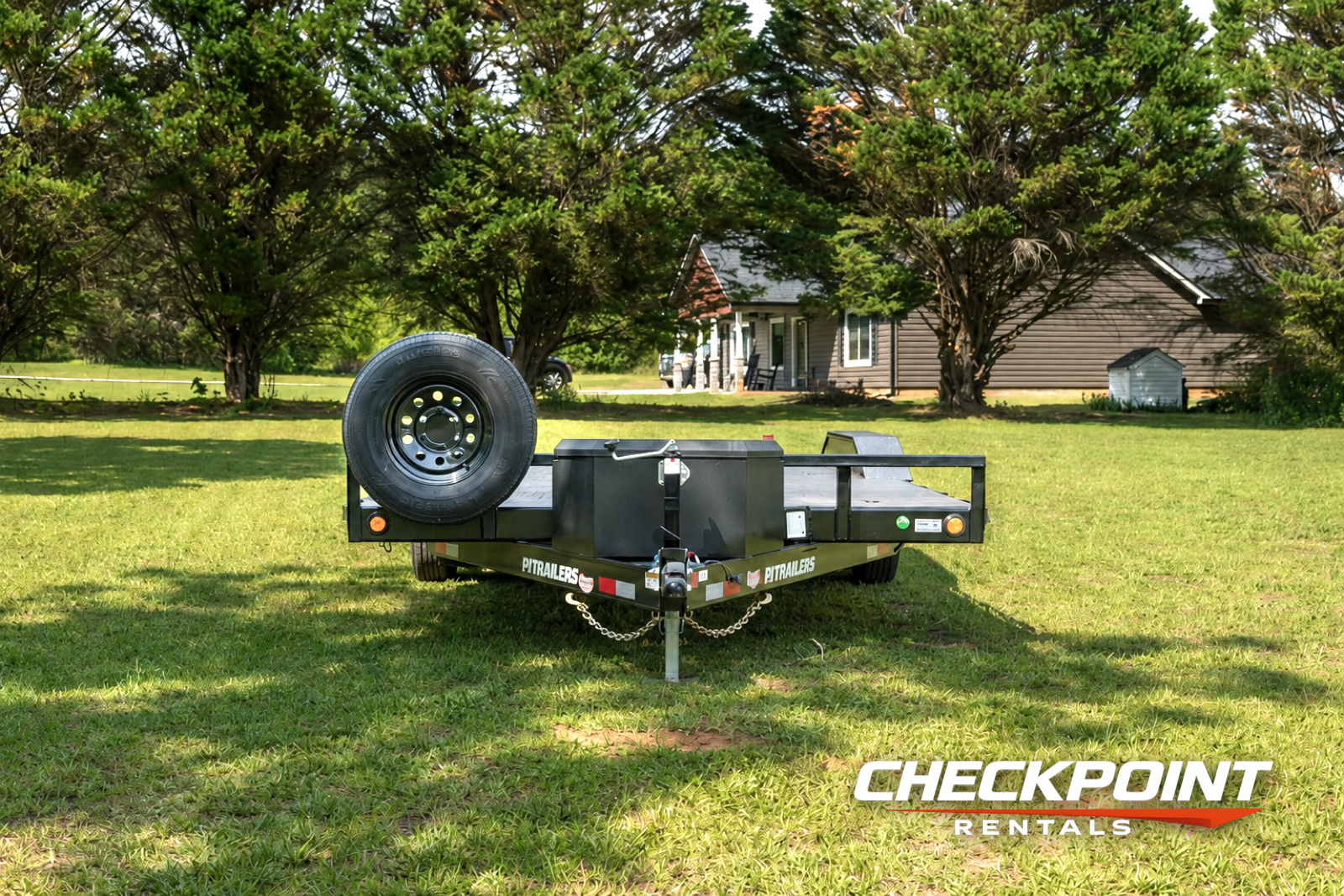 PJ Trailers car hauler front angle showing spare tire mount and winch box