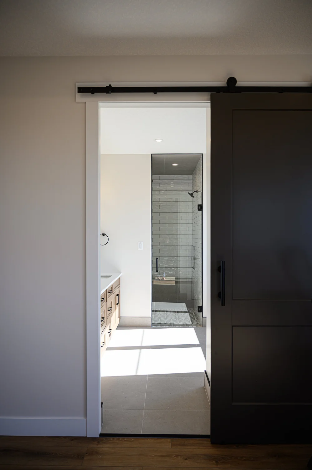 Black barn door leading to bathroom