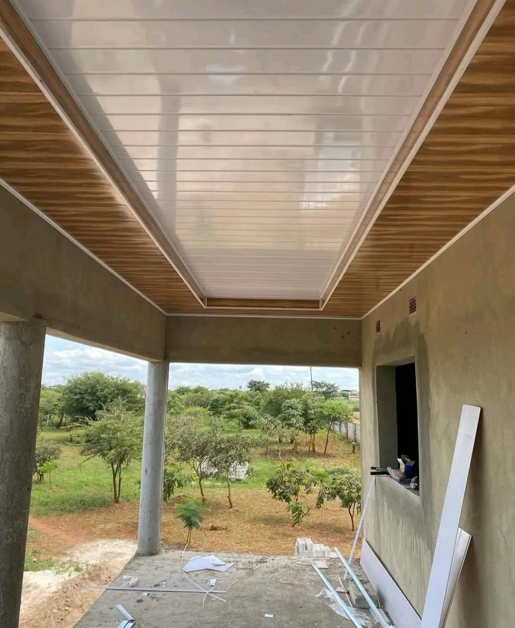 Covered patio with a white panel ceiling framed by timber-look details