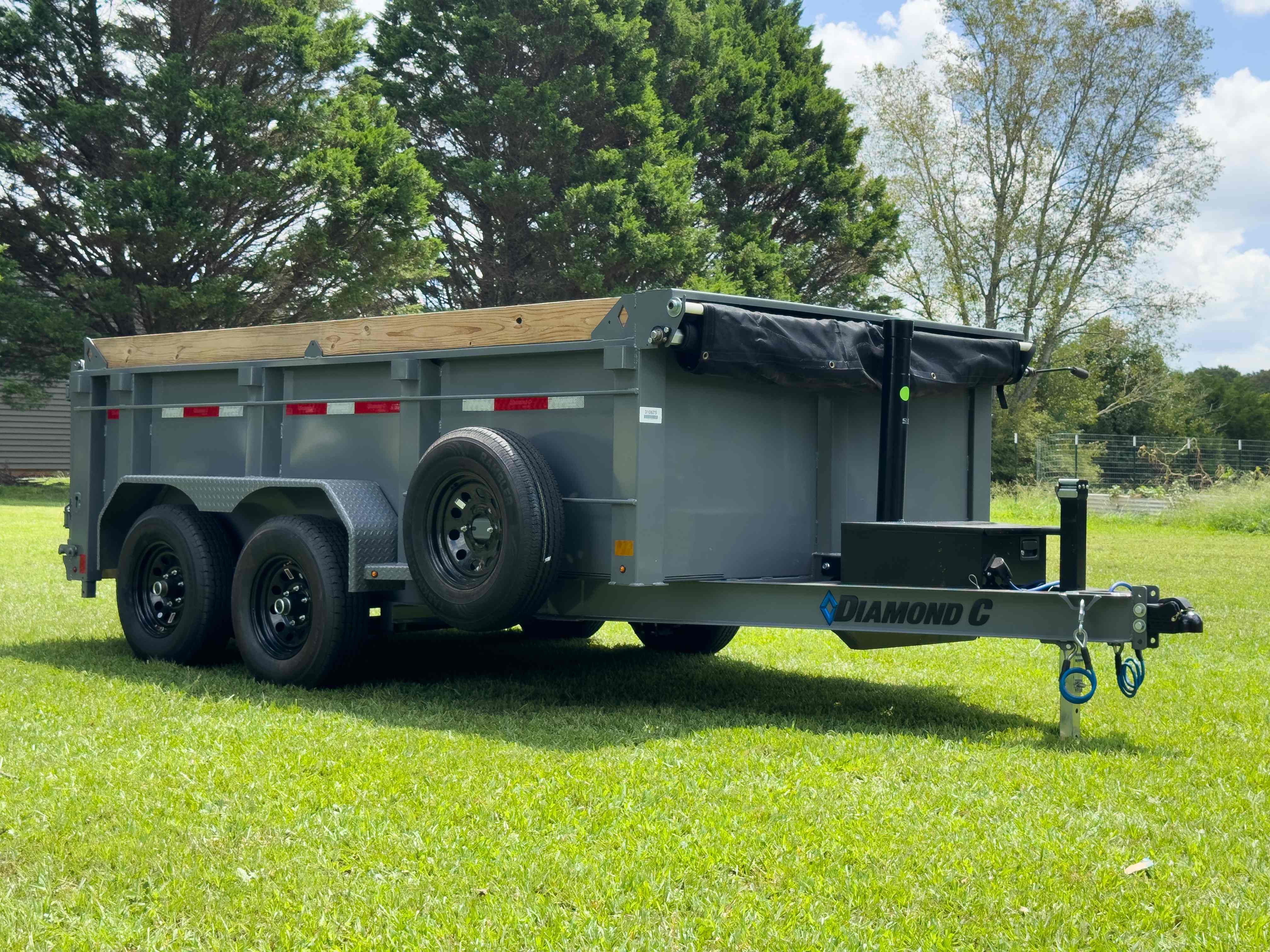 Diamond C dumpster trailer full side profile view showing tarp system