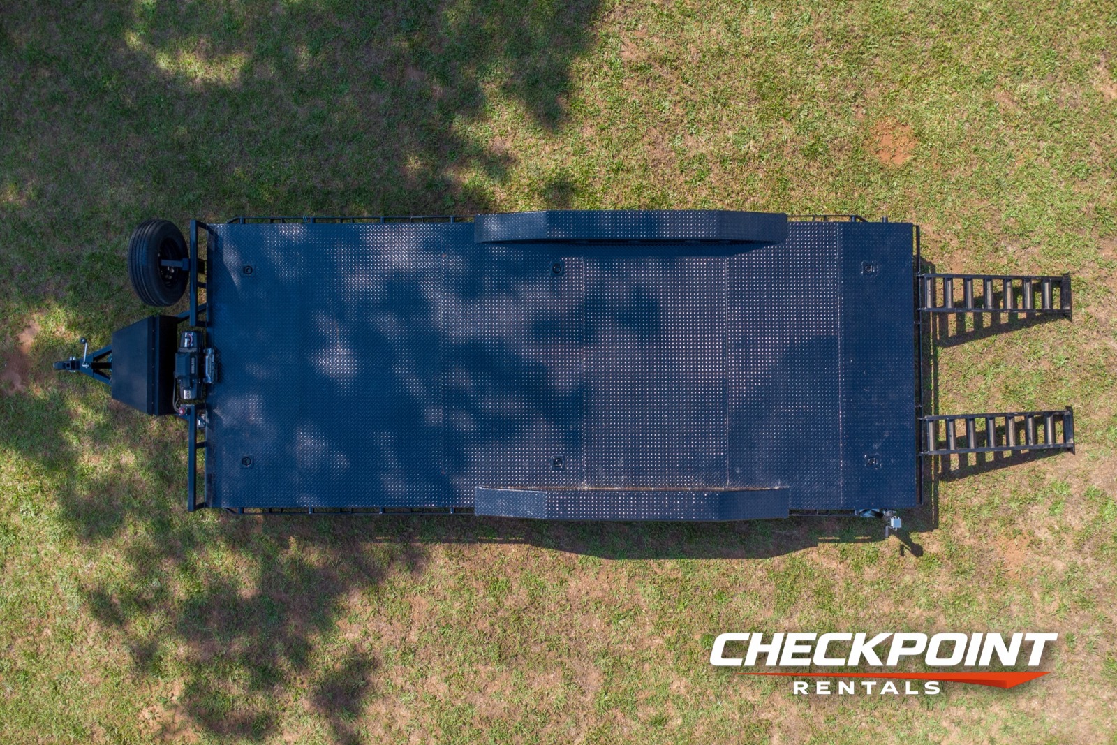 Aerial drone top-down view of full 20-foot car hauler trailer