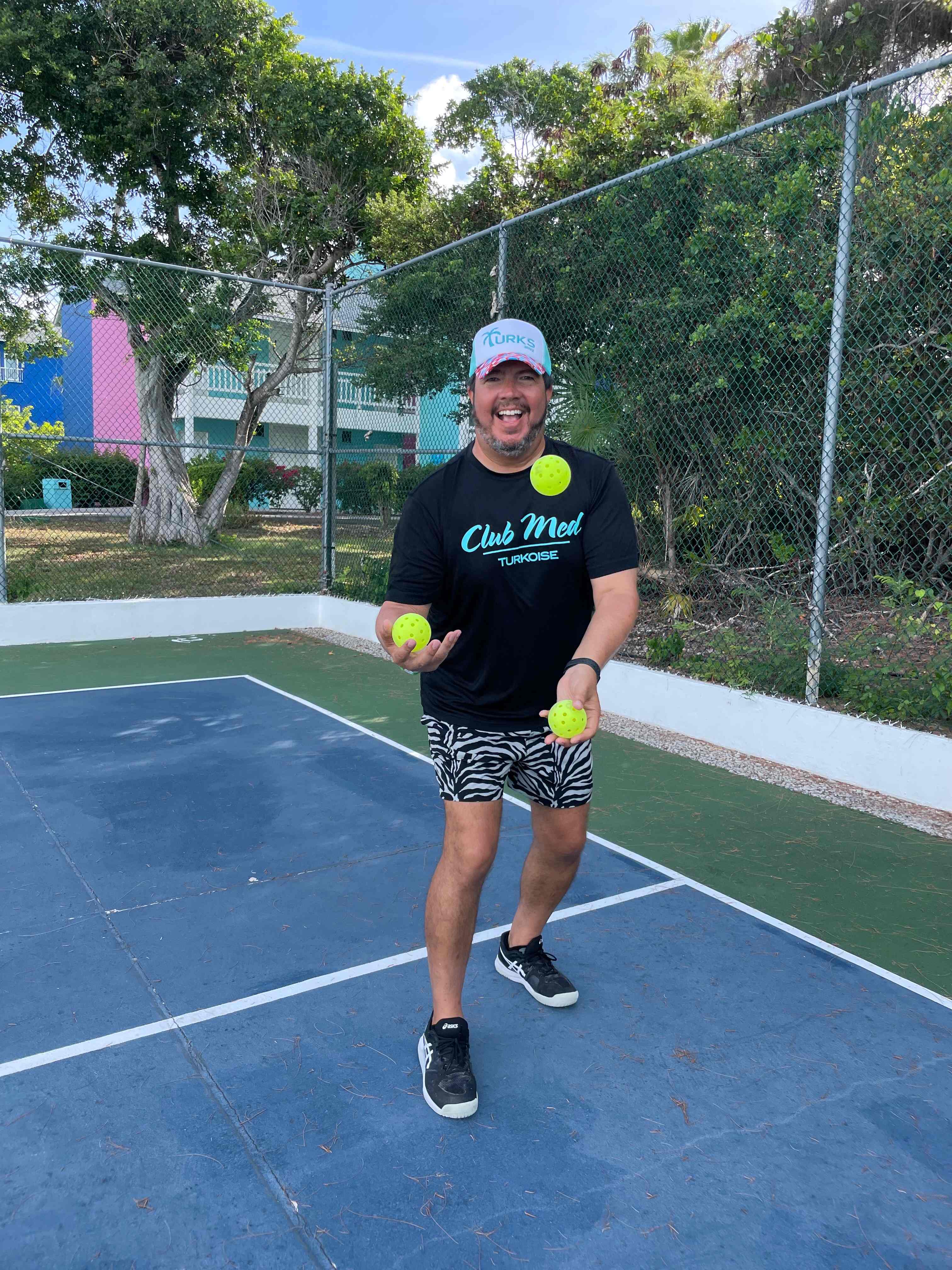 Coach James juggling pickleballs on court