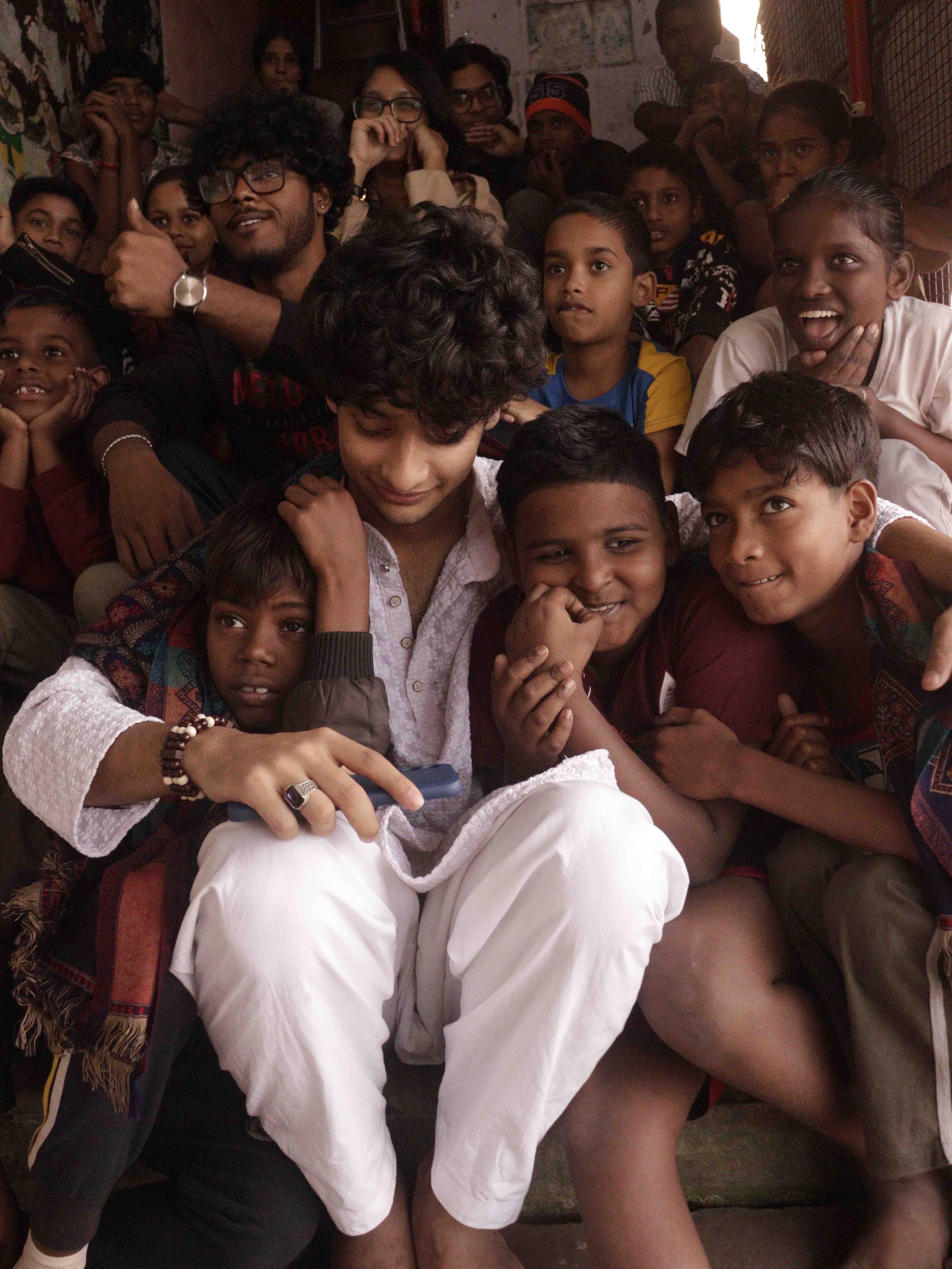 Mentor surrounded by children with warmth