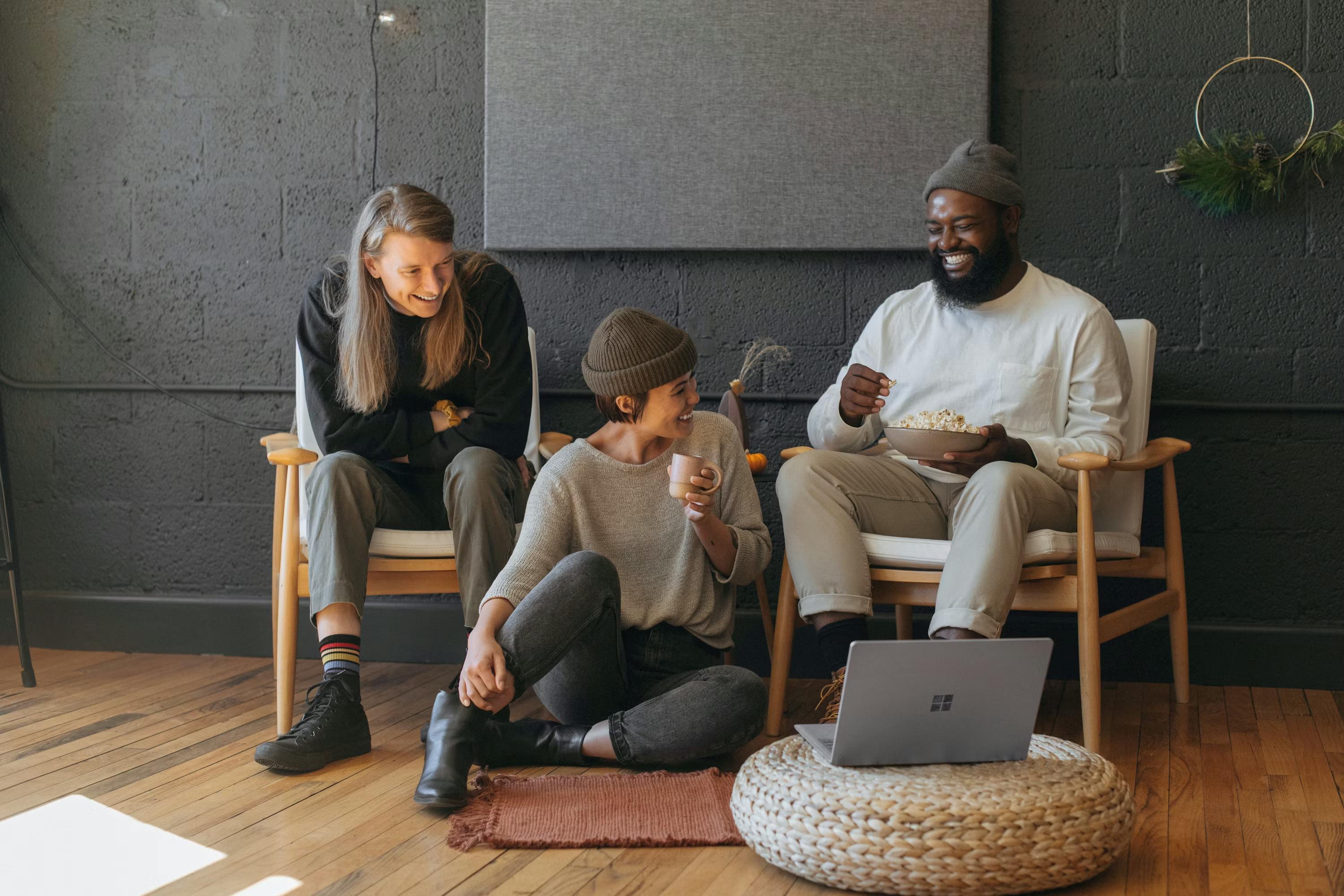 A team laughing together while working from a cozy living room