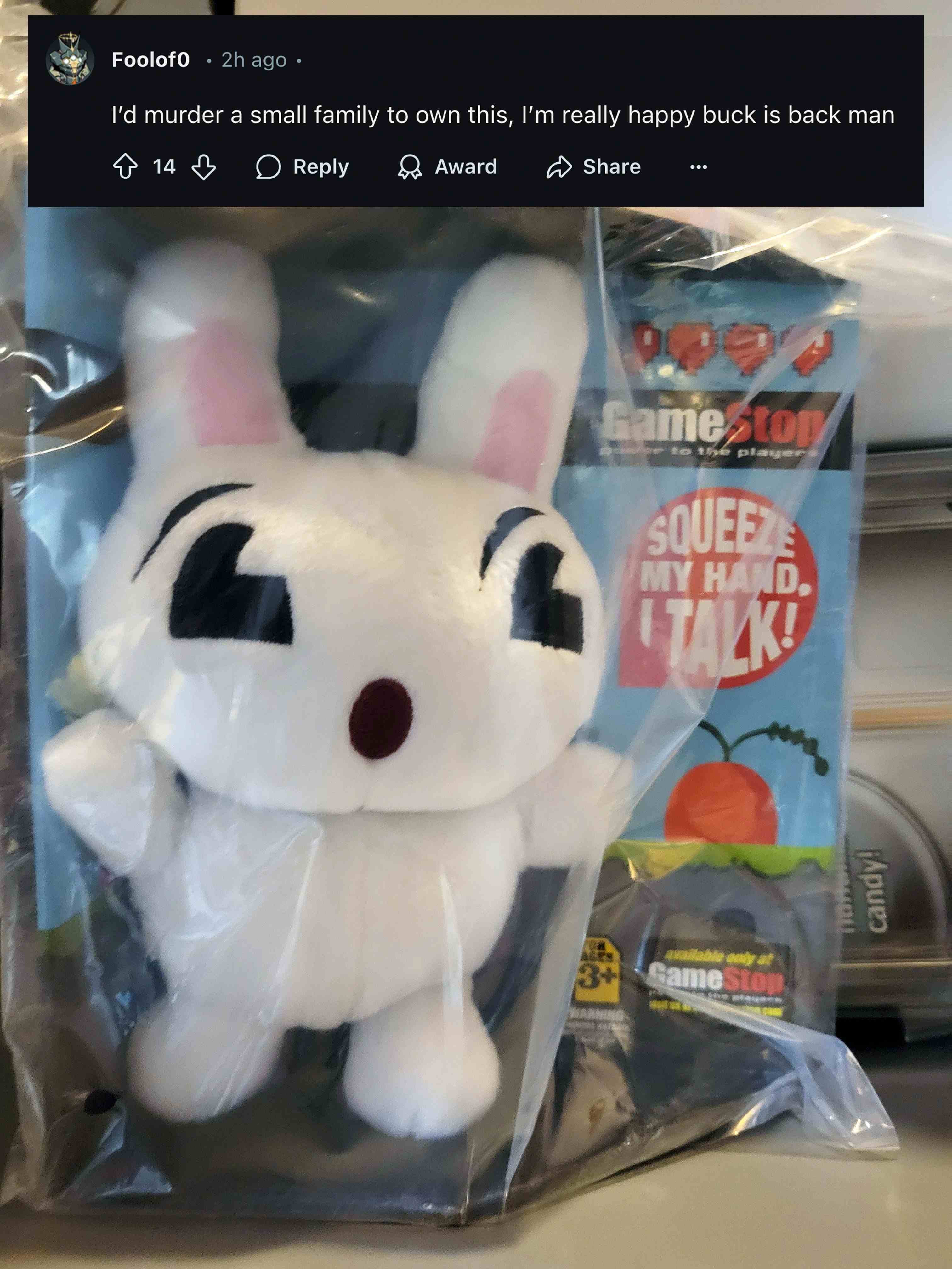 Buck plush in front of a GameStop display with a community reaction overlay