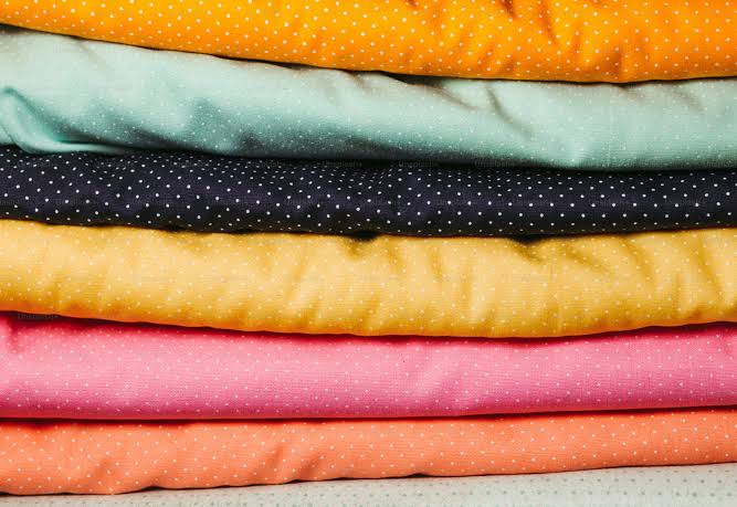 Stacked colorful fabrics with polka dot patterns