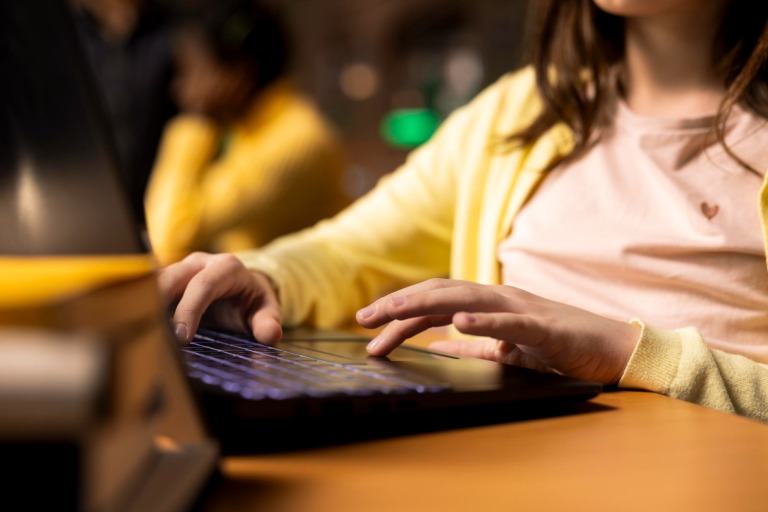 Child typing on keyboard