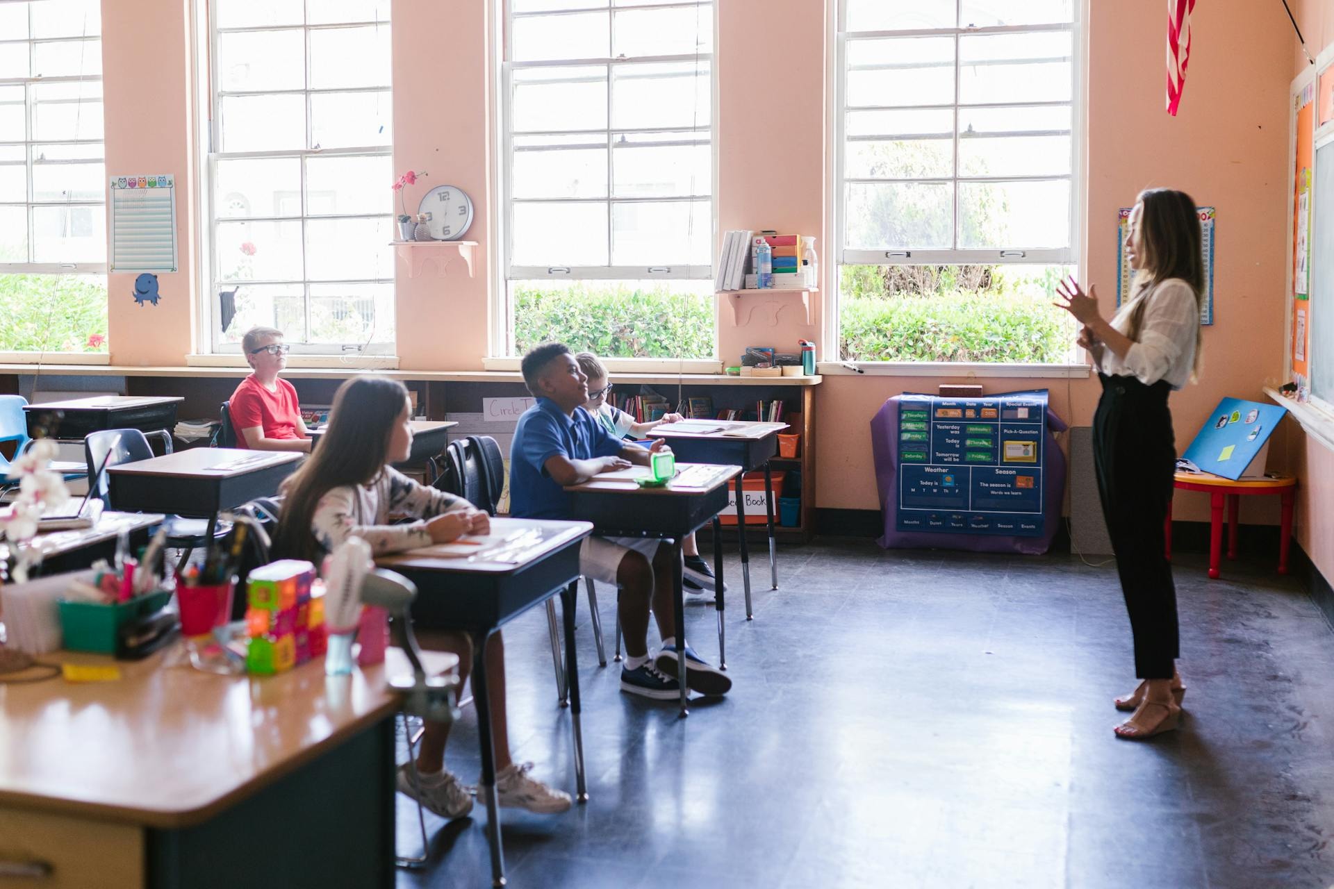 Teacher with students in colorful classroom