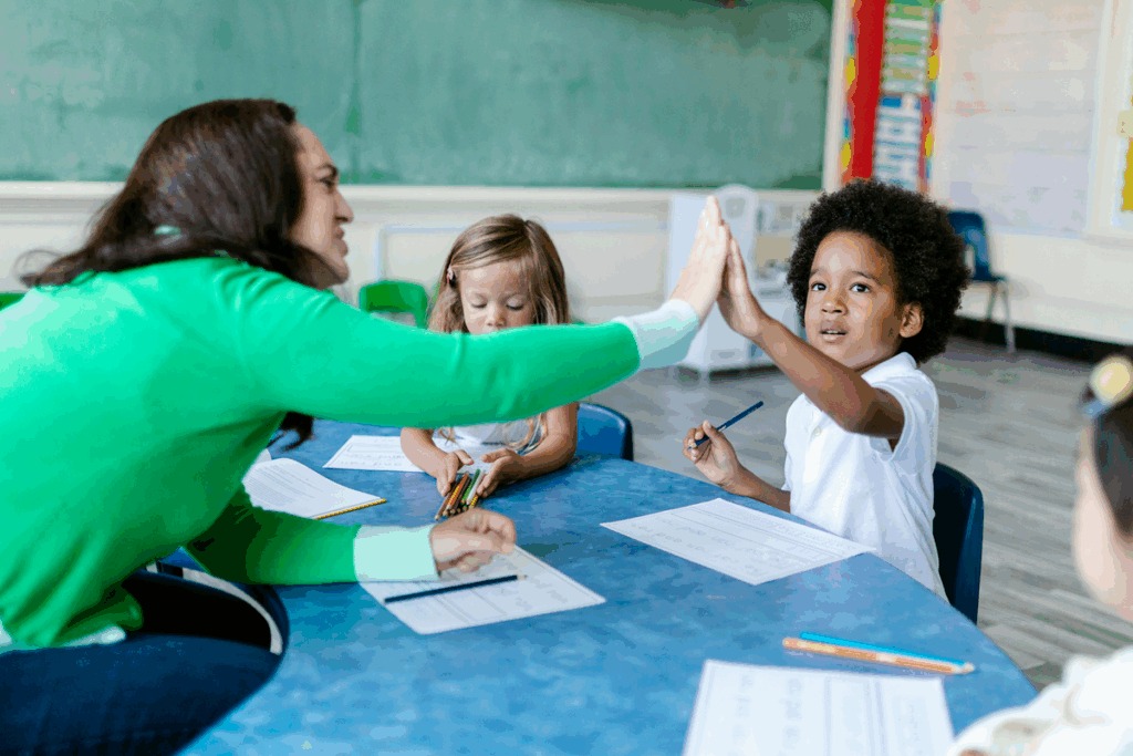 Teacher celebrating with student